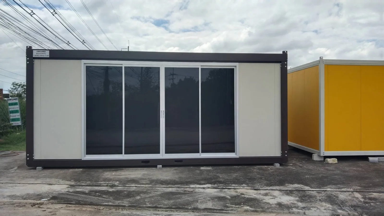 Knock-down office unit with cream walls, dark-brown frame and four sliding glass doors (view 2)