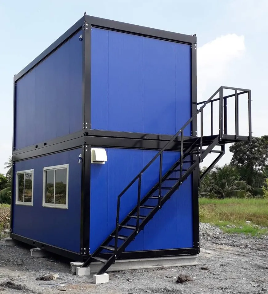 Two-storey blue knock-down worker housing with external steel stair, balcony and separate doors (view 3)