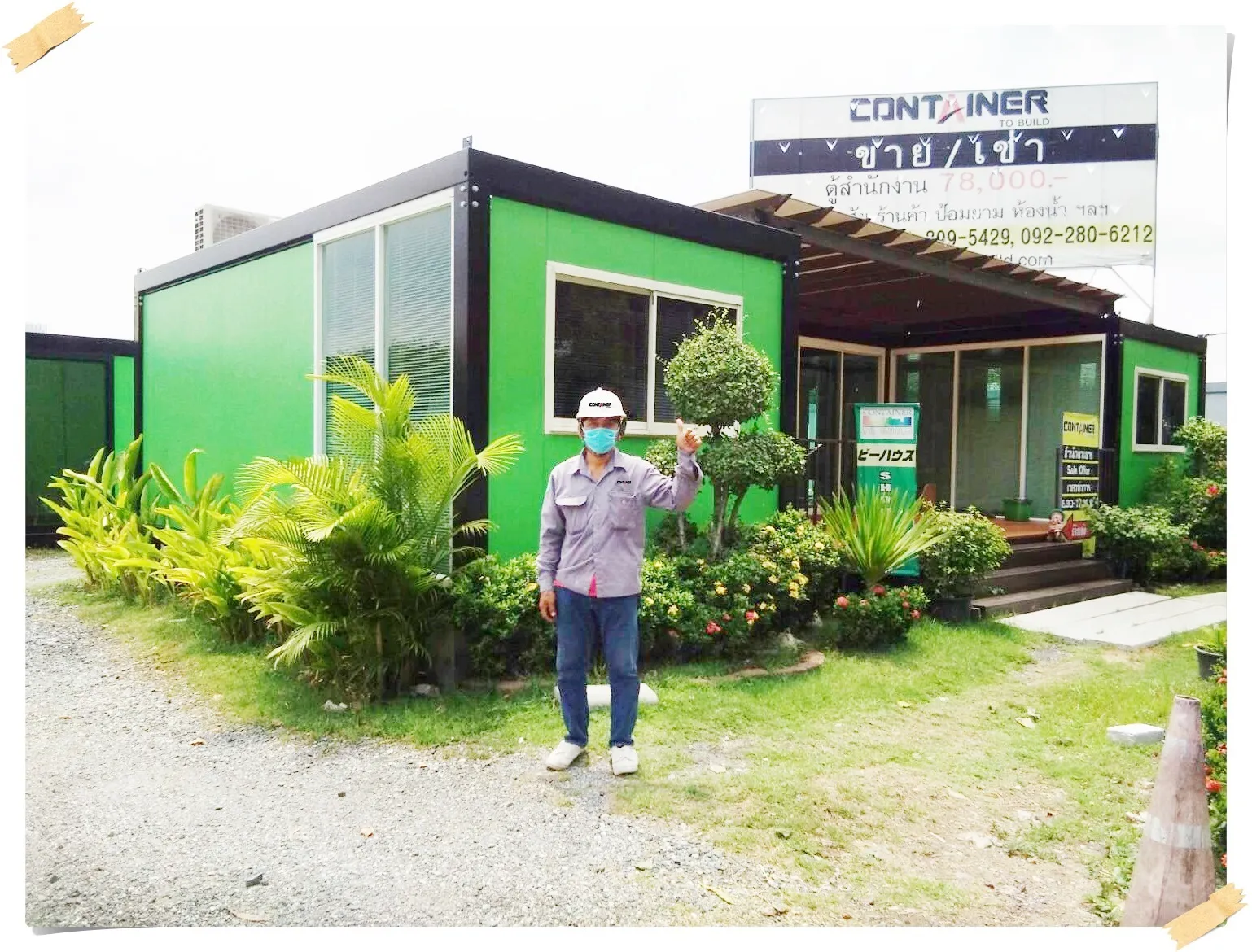 Container To Build staff in front of a green office unit at the showroom