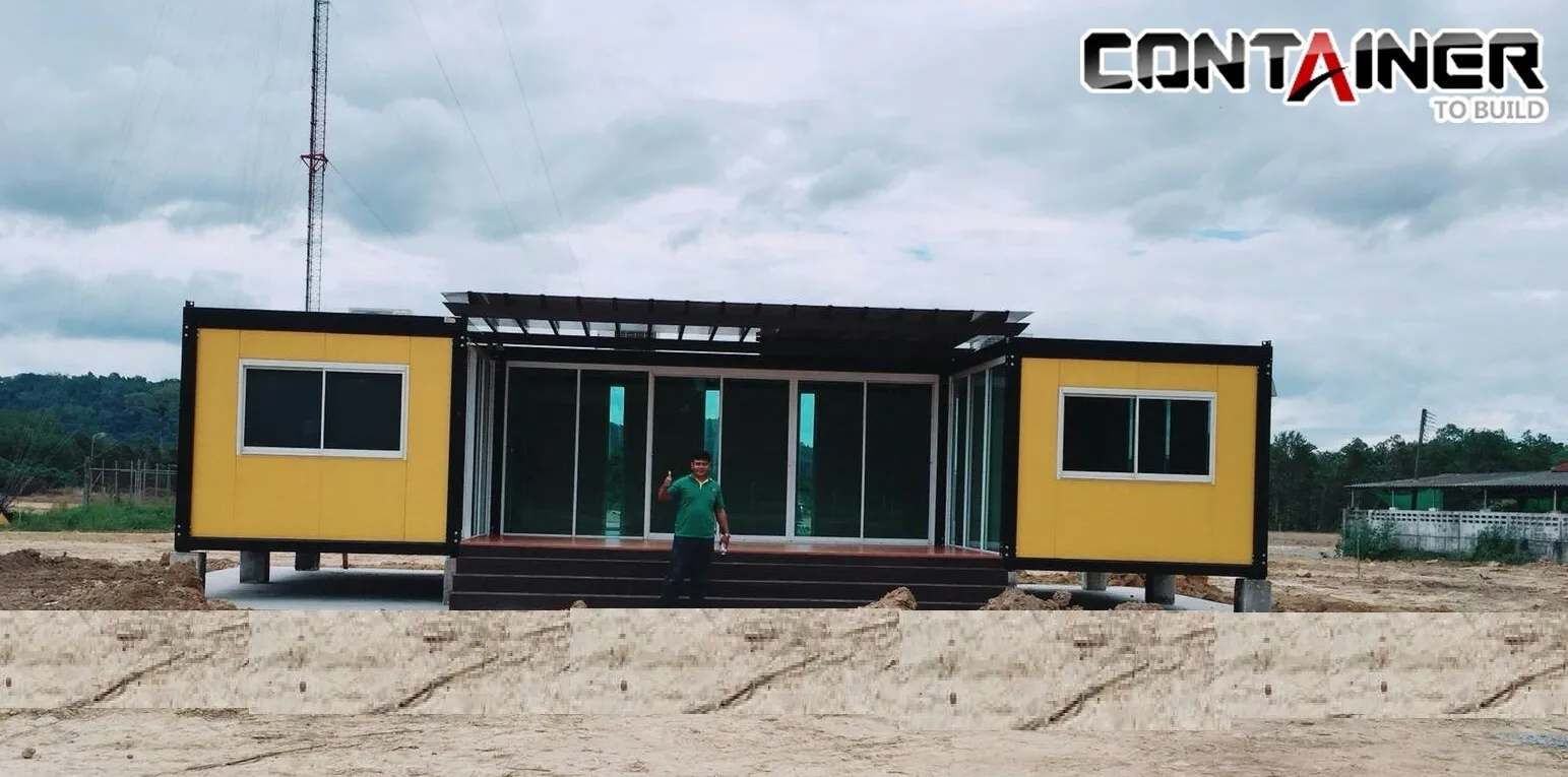 Two yellow knock-down office units joined by a glass hall and black steel pergola, raised on footings
